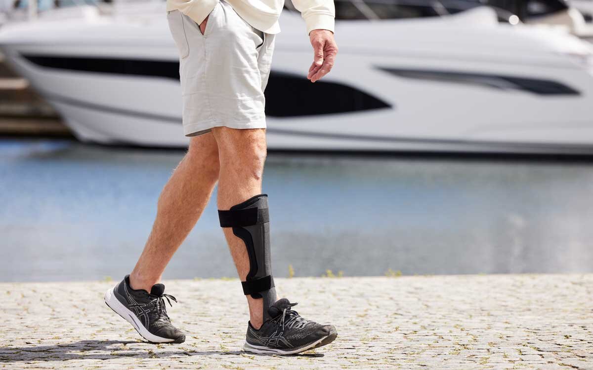 Beskåret bilde av en person som bruker ToeOFF dropfotsortose.